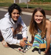A photograph of two students working together. 